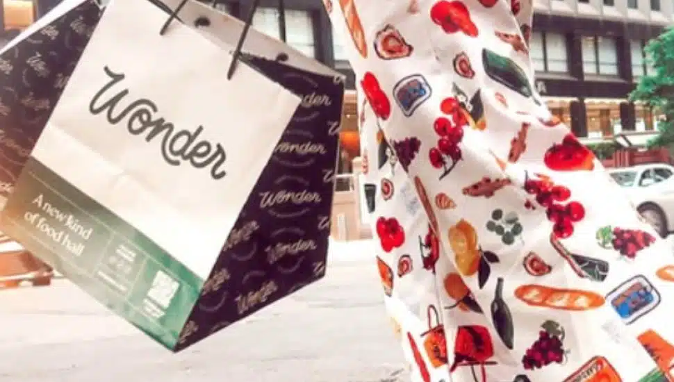A woman in colorful pants carries out her Wonder ToGo bag.