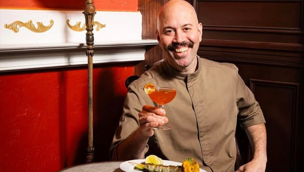 Yun Fuentes holding a drink and smiling.