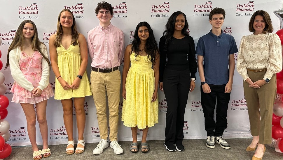 High school seniors receive scholarships from credit union CEO.