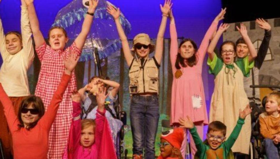 The Acting Without Boundaries cast is celebrating onstage.
