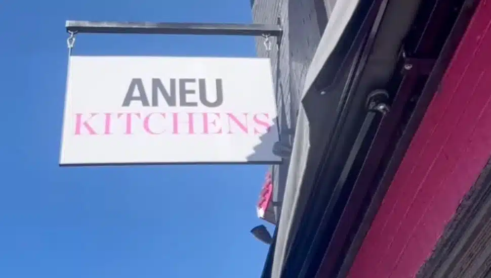 Aneu Kitchens sign hangs outside of the restaurant.
