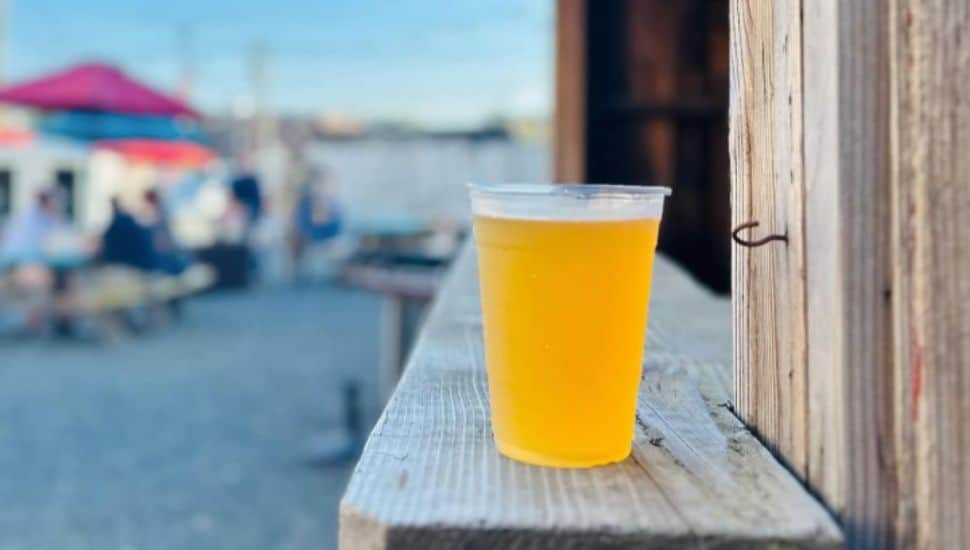 A cold beer sitting in the forefront of The Alley on High Street.