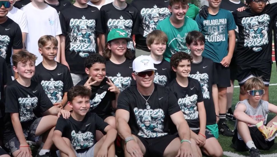 Cooper DeJean poses with young players at the Haverford School's football camp.