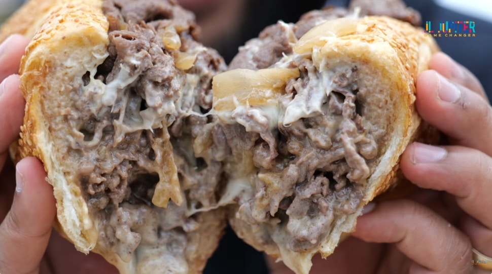 A cheesesteak cut in half.
