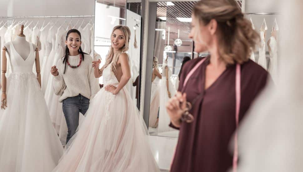 Young women looking at the wedding dress designer while in David's Bridal.