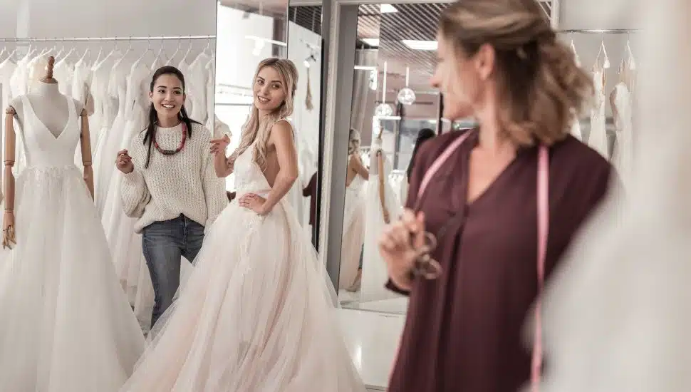 Young women looking at the wedding dress designer while in David's Bridal.