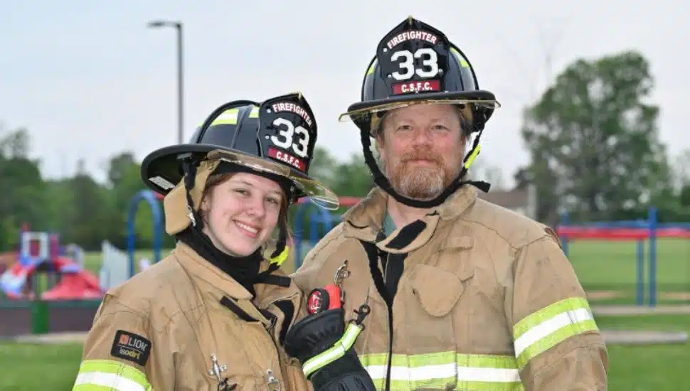 Emma and Bob Scott dressed in Centre Square Fire Company uniforms.