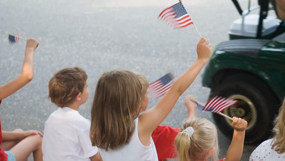 Children waving American flags at the Whitemarsh Fourth of July Parade.