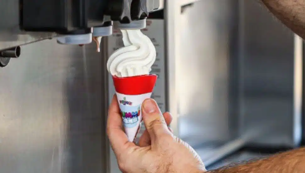 Soft serve ice cream poured into a red Gummi Cone.