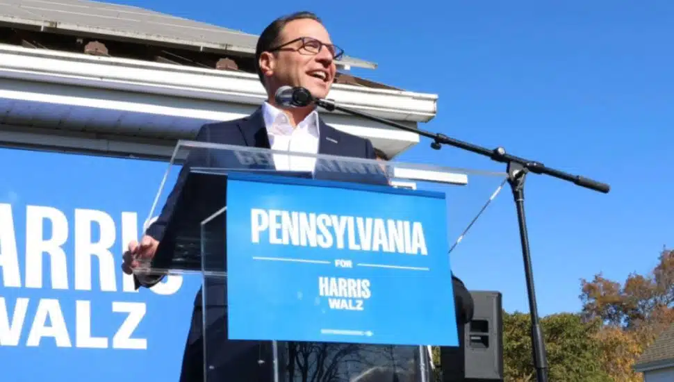 Josh Shapiro speaking at a podium on the campaign trail.