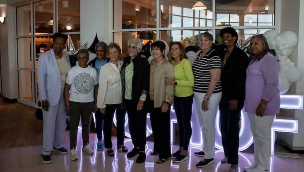 Lucille Kyvallos and other inductees lined in a row smiling.