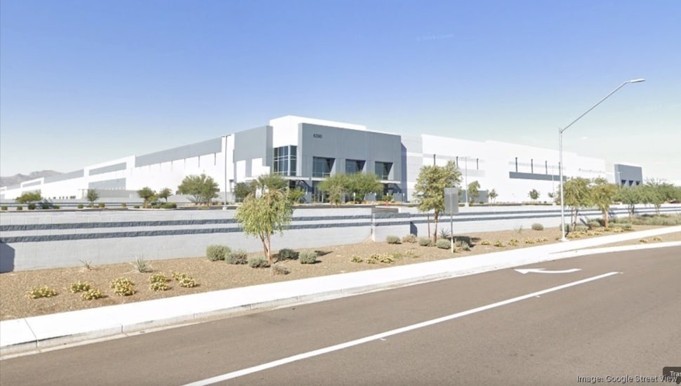 A large building next to a highway.
