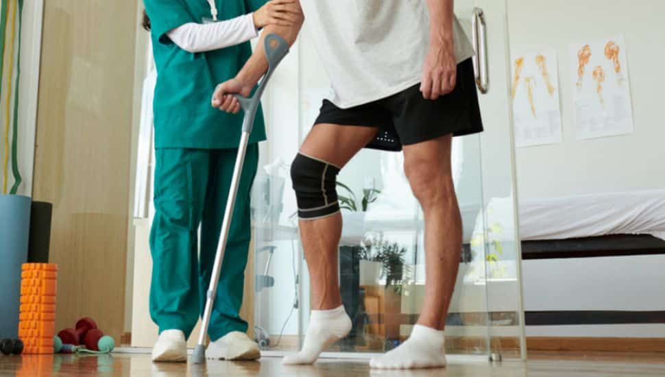 A nurse assists a patient with walking.