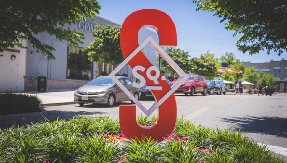 The Suburban Square statue in front of the stores.