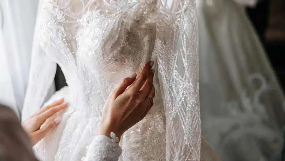 Bedroom interior with wedding dress prepared for the ceremony. A beautiful lush wedding dress on a mannequin in a hotel room.