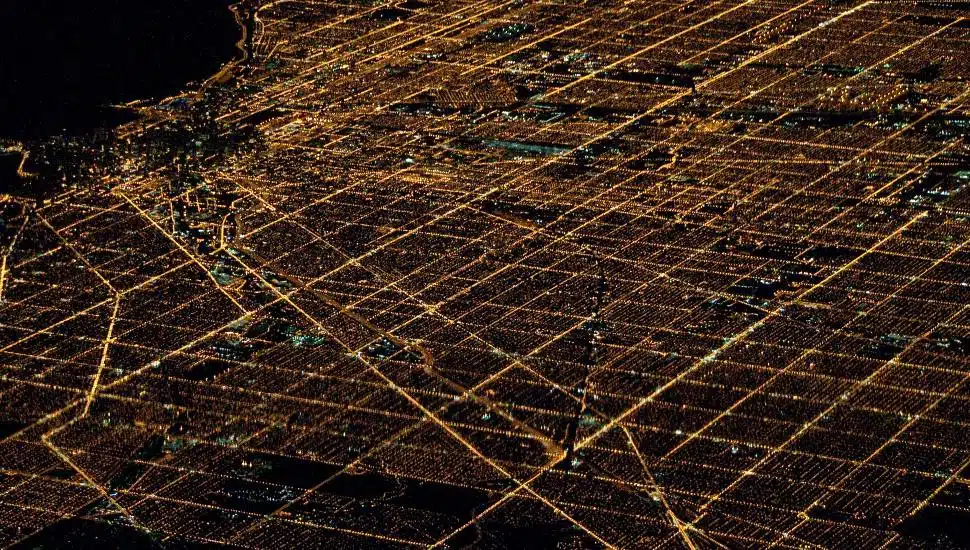 Aerial view of city lights going through the streets of an urban center.