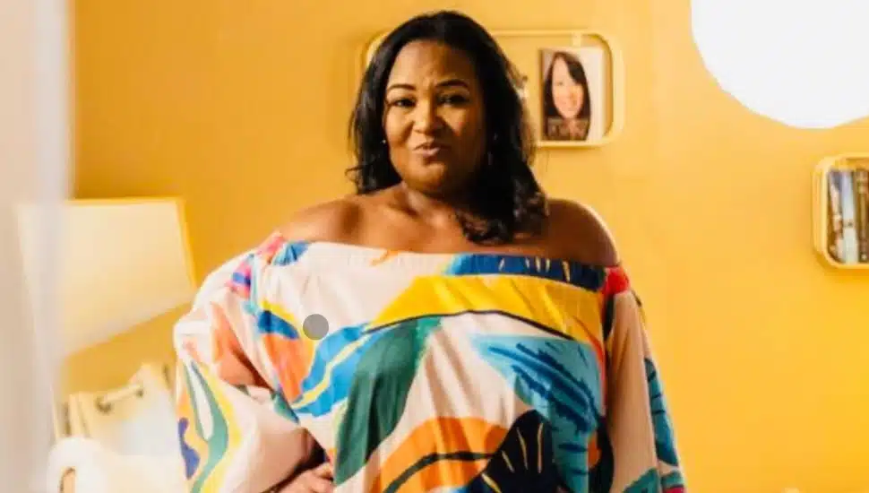Nakea Murray posing in a colorful dress.