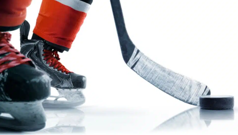 Hockey skates, puck and stick close-up.