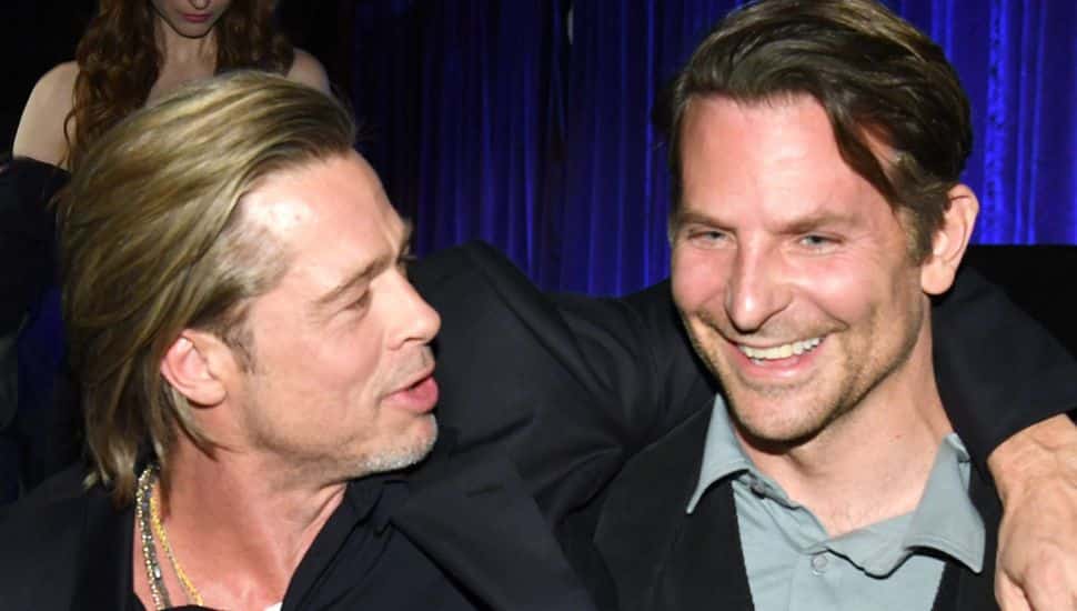 Brad Pitt wraps his arm around Bradley Cooper.