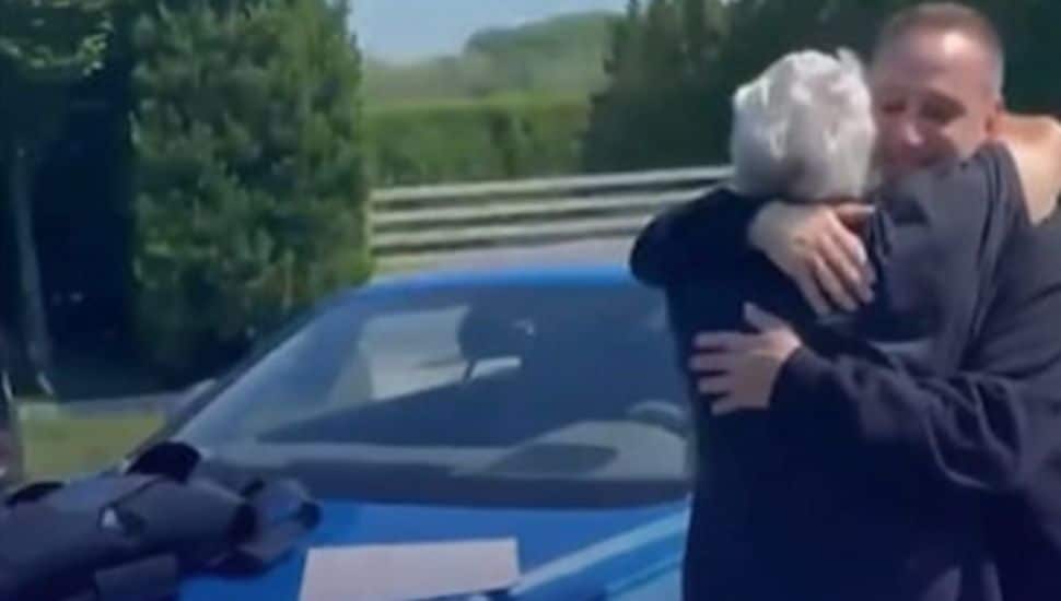 Robert Kraft hugs Michael Rubin after receiving $240,000 car for his 80th birthday.