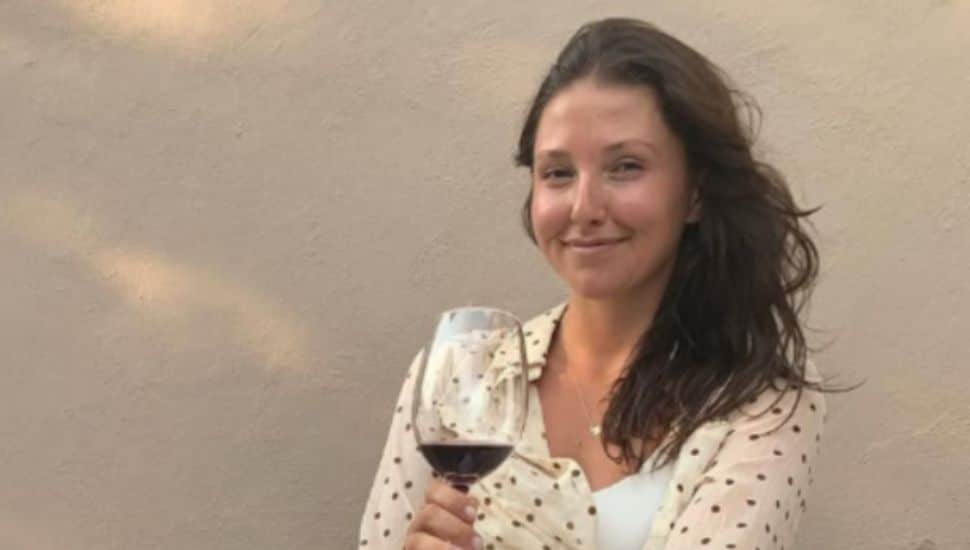 Collective Boutique's Victoria Totaro sips red wine.