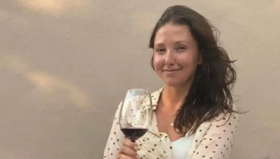 Collective Boutique's Victoria Totaro sips red wine.