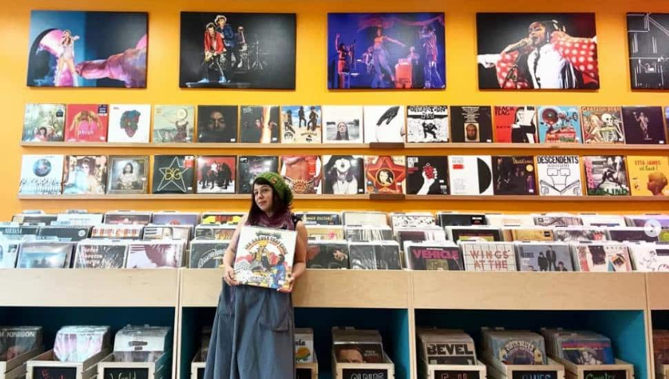 Owner Lisa Schaffer holds a record inside her store, Vinyl Chickie.
