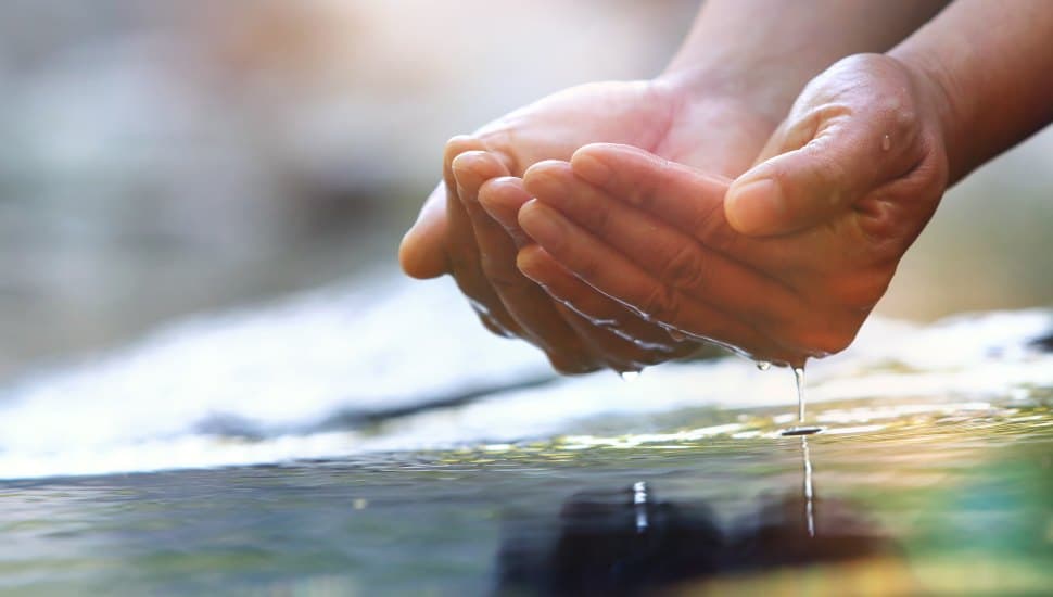 Precious water in your hand, clear, transparent and clean.