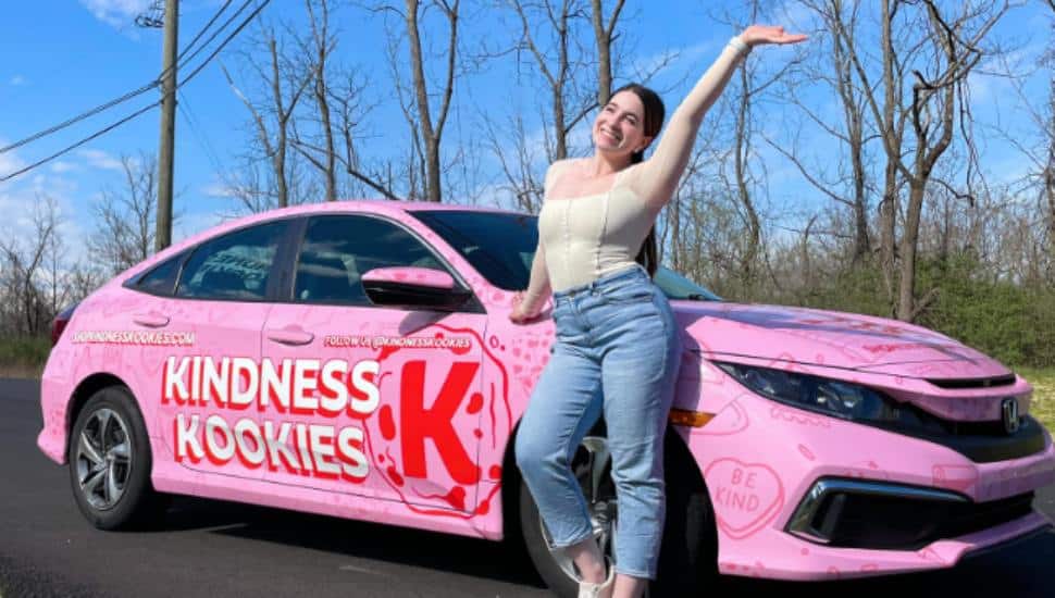 Ashley Greenberg stands beside her Kindness Kookies Kookie Mobile.