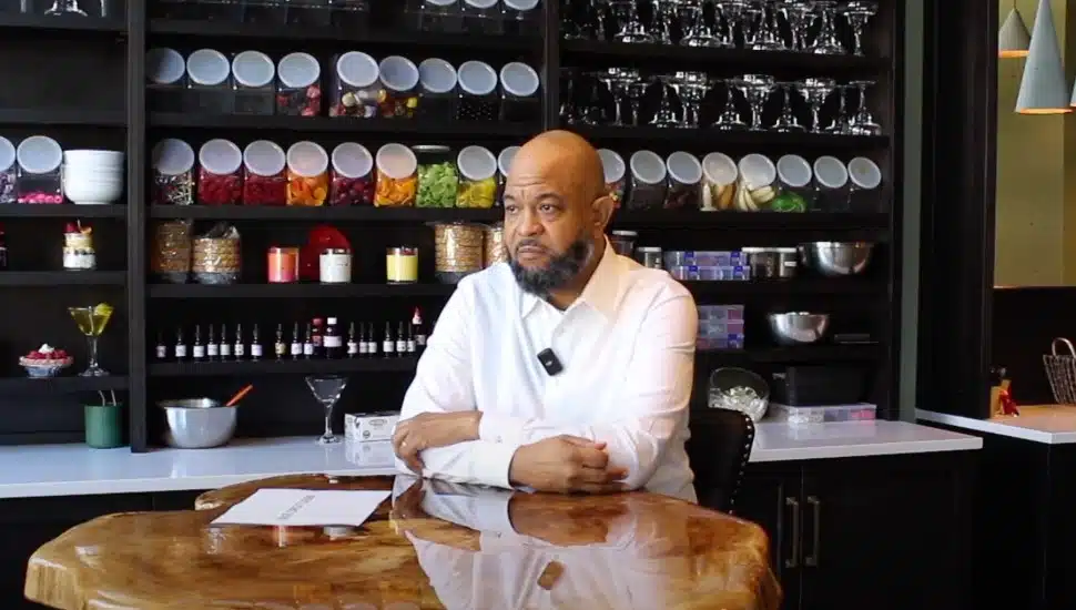 Chris Holloway sits at a table in his Cork & Candles shop.