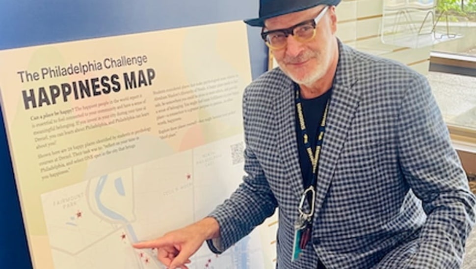 Eric Zillmer pointing to the "Philadelphia Happiness Map."