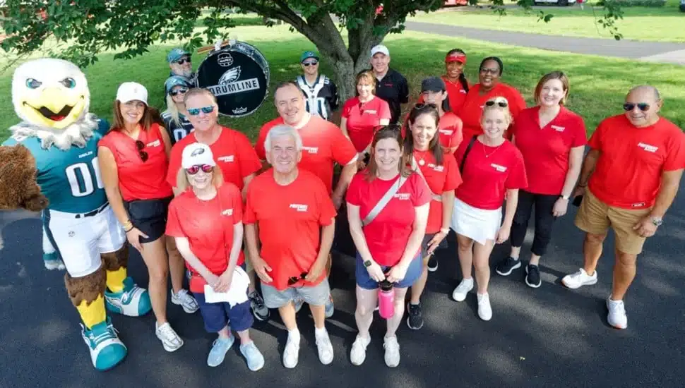 Group photo of bank volunteers in red shirts.