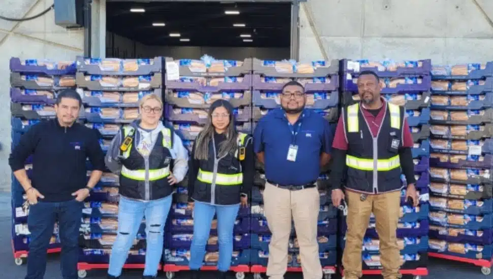 Grupo Bimbo staff stand by a delivery of bread.