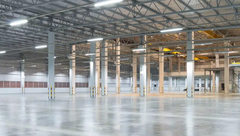 Empty factory building or warehouse building with concrete floor for industry background.