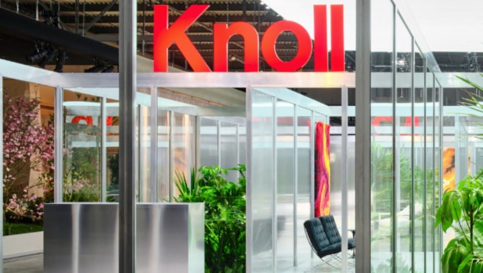 A sign for Knoll hangs over office furniture.