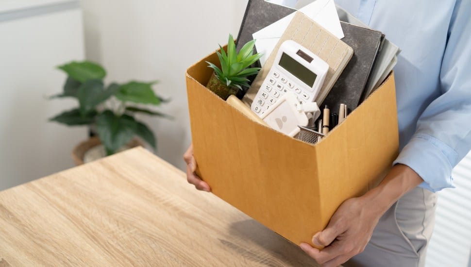 Business man sending resignation letter and packing stuff.