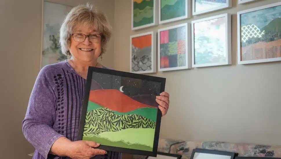 Linda Dubin Garfield holding painting.