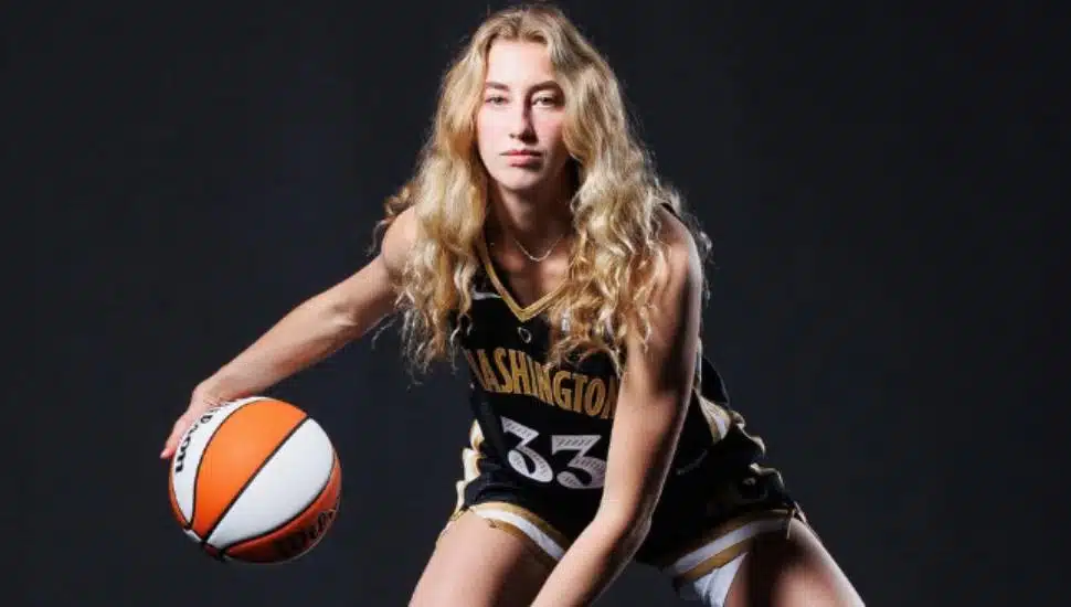 Lucy Olsen dribbles a basketball in her Washington Mystics uniform.