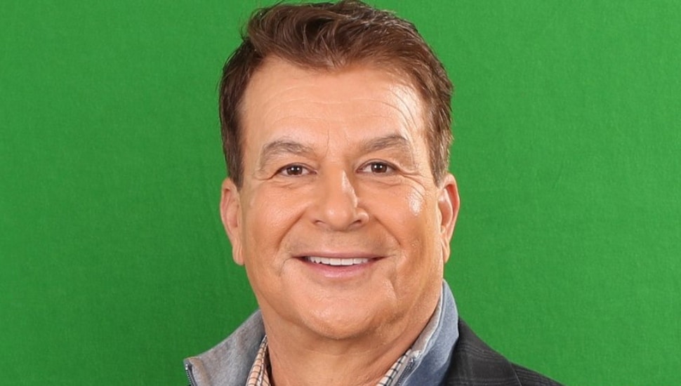 Mike Missanelli headshot with green background.