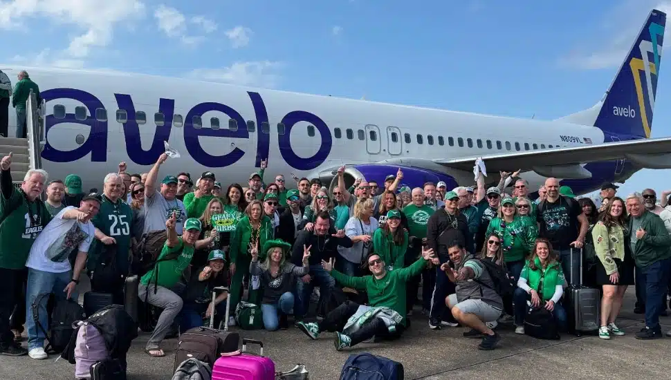 Eagles fans gather outside of a private plane on the way to an away game.