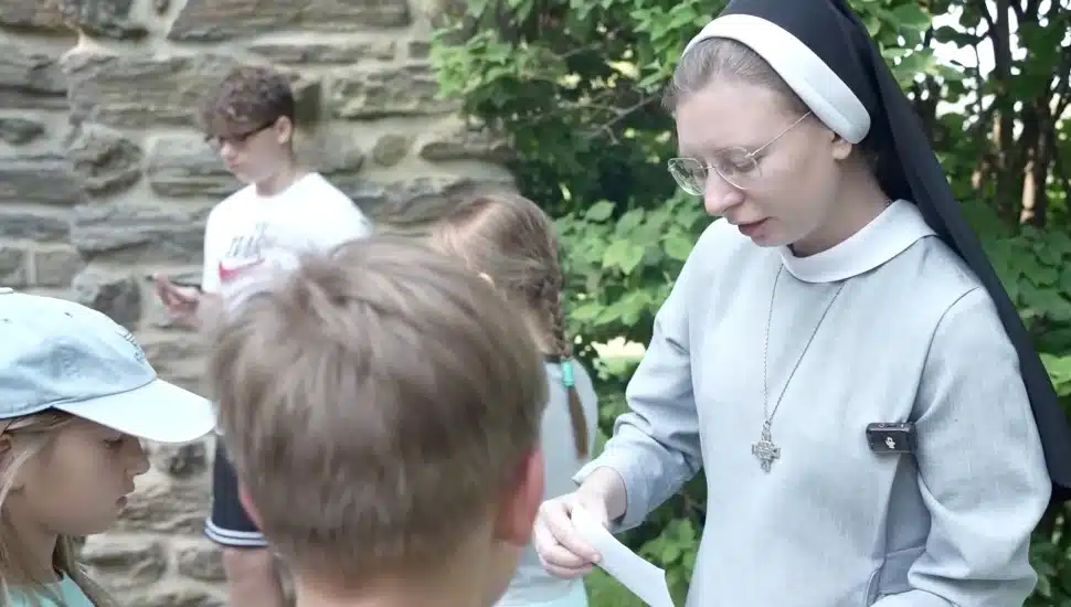 Sister Esther Kozun speaks to children.