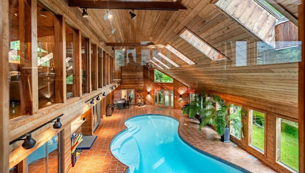 Indoor pool with wood walls and flooring.