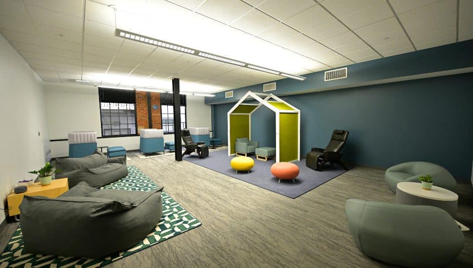 A modern sensory room at MCCC's Pottstown Campus Wellness Center featuring bean bags, lounge chairs, colorful seating pods, and soft lighting to promote relaxation and mental wellness.