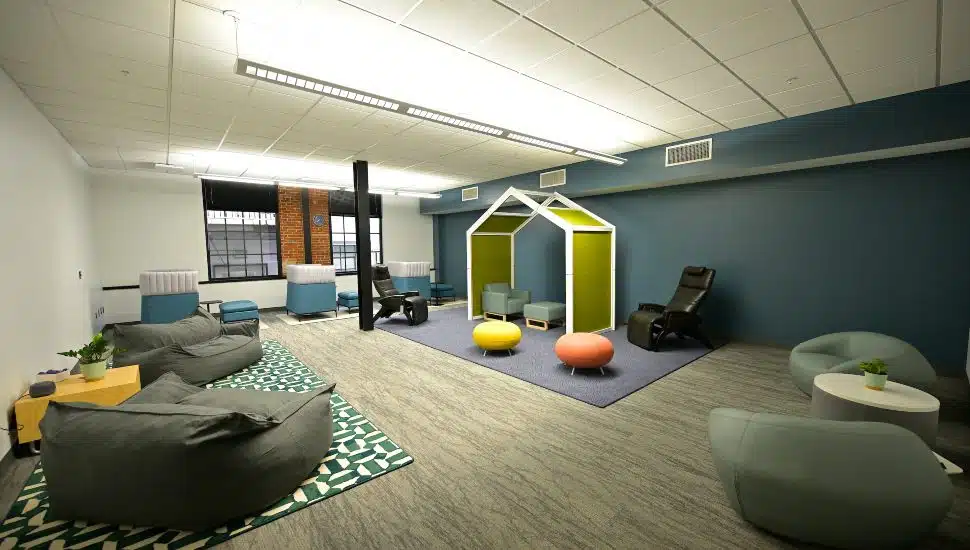 A modern sensory room at MCCC's Pottstown Campus Wellness Center featuring bean bags, lounge chairs, colorful seating pods, and soft lighting to promote relaxation and mental wellness.