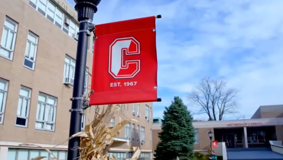 A flag for Archbishop Carroll hangs outside the school.