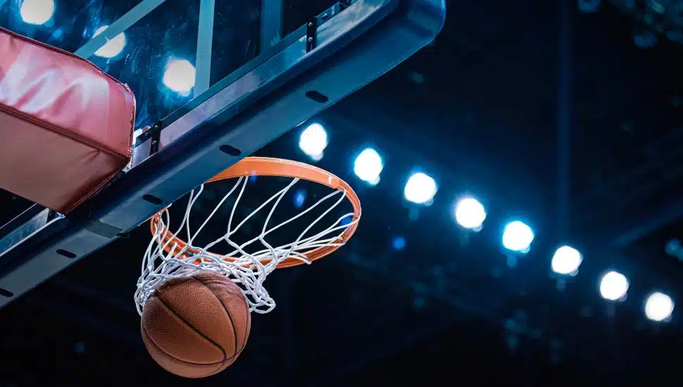 A basketball falls through a hoop.