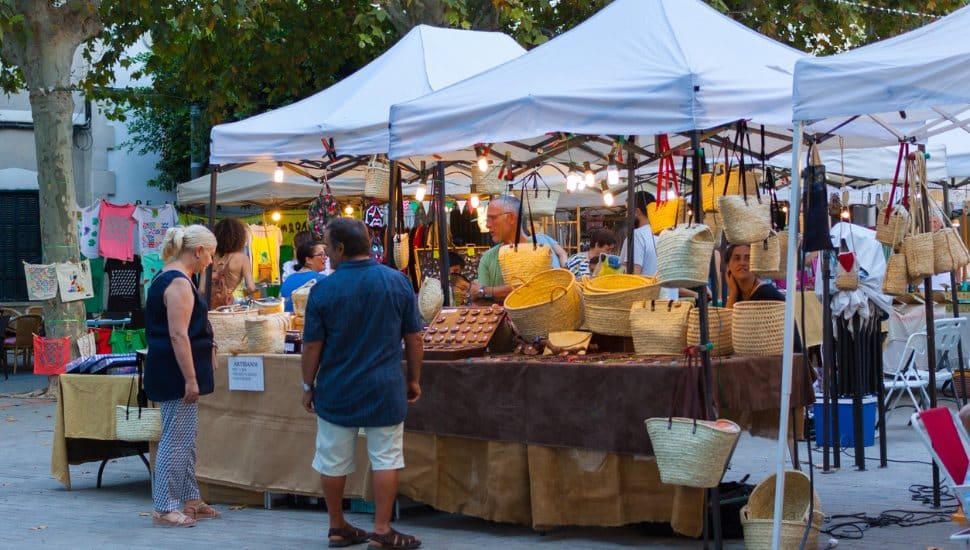 Shoppers at an outdoor art market.