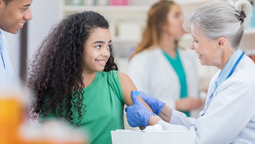 Young girl gets a flu shot.
