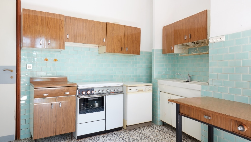 Old kitchen interior with turquoise tiles in old house