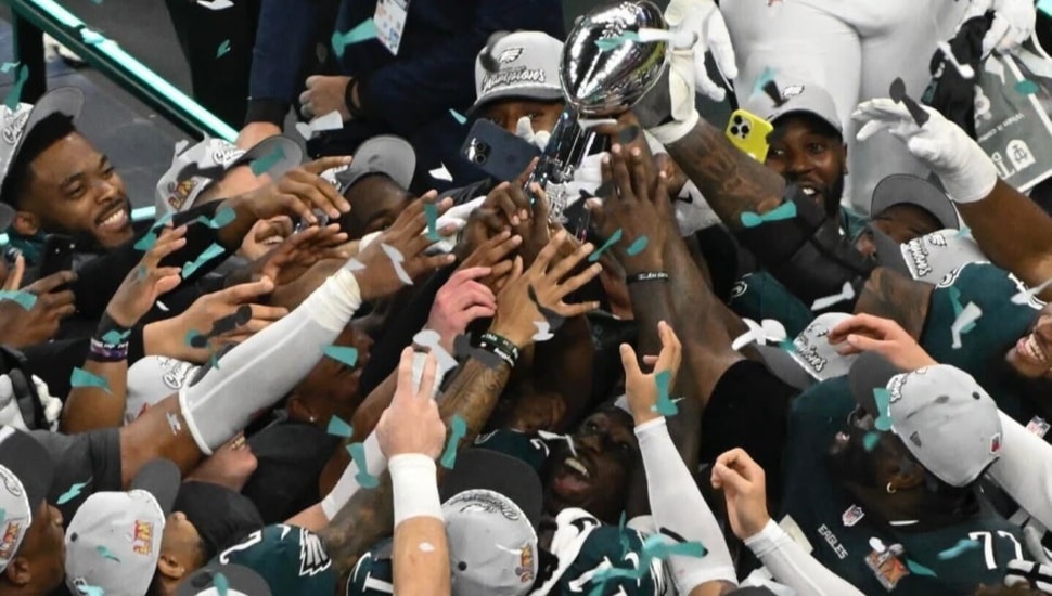 Th Philadelphia Eagles hoist the Lombardi Trophy after winning the Super Bowl.